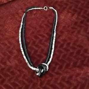 Women's black and silver necklace.